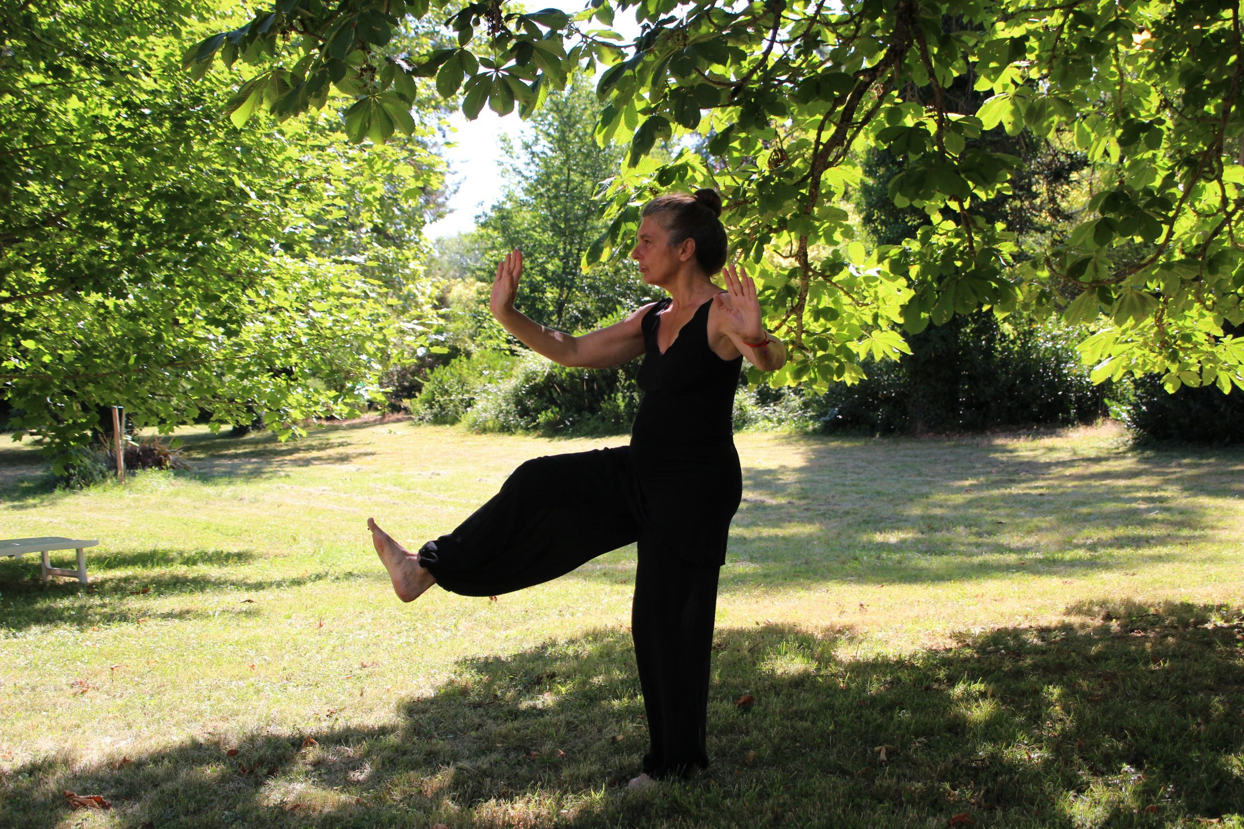 Woman practices Tai Chi outside the Betty Ford Alpine Gardens